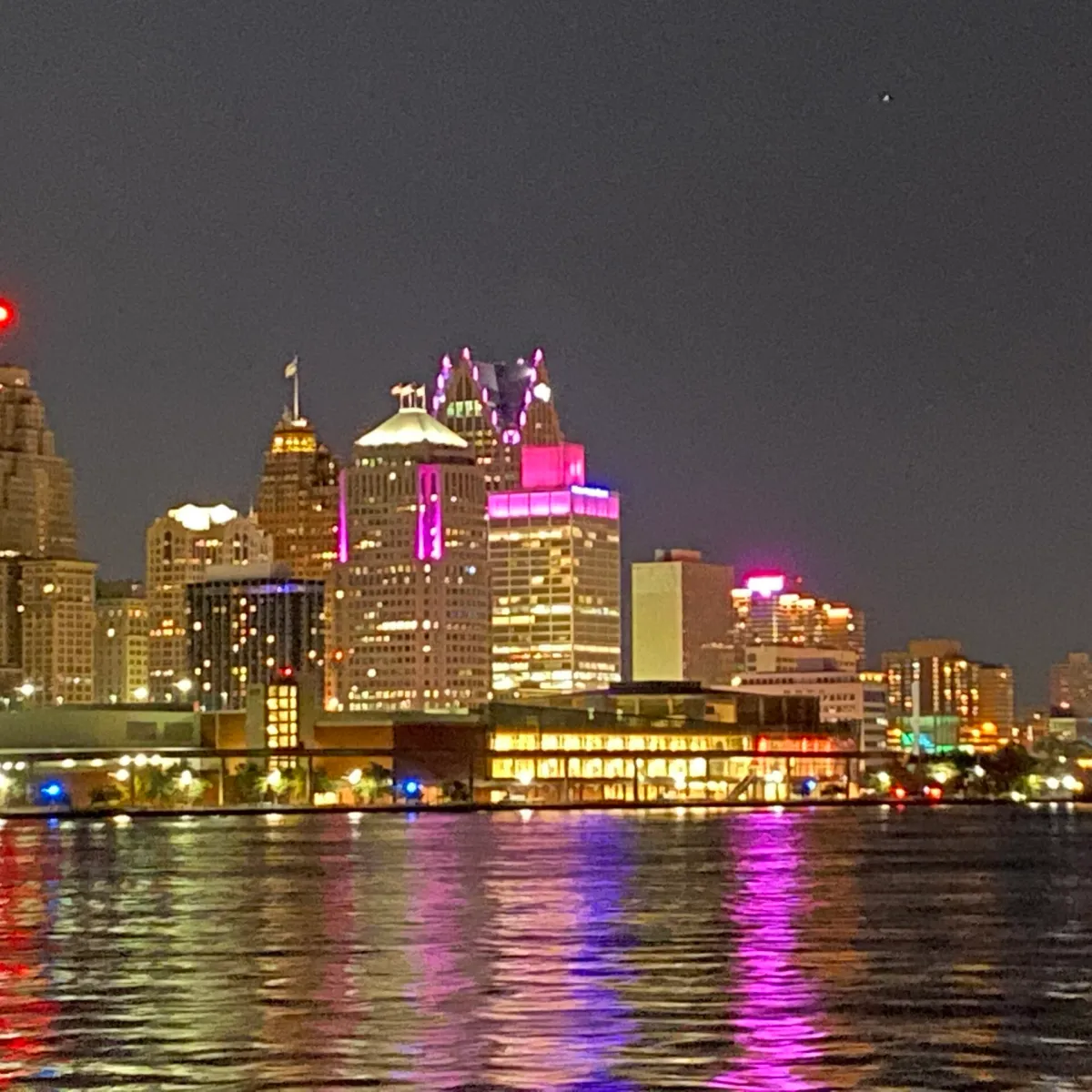 a body of water with a city in the background
