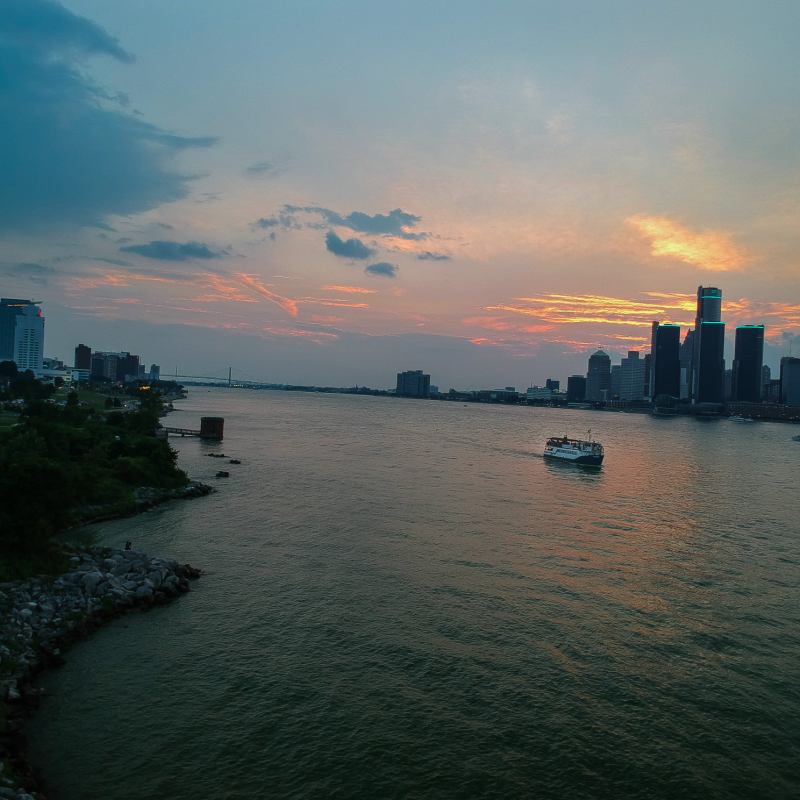 a body of water with a city in the background