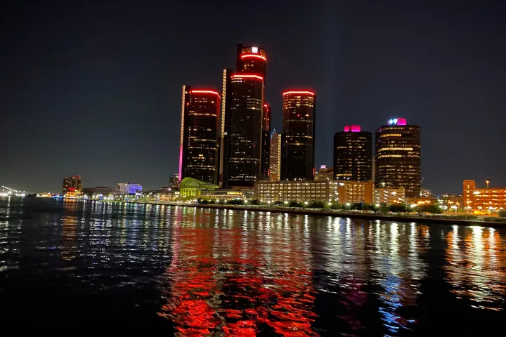 a body of water with a city in the background