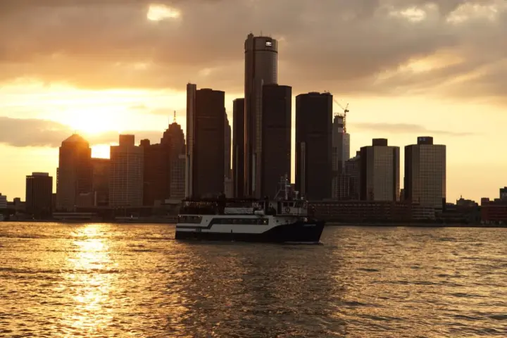 a large body of water with Renaissance Center in the background