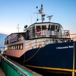 a train sitting on the side of a boat