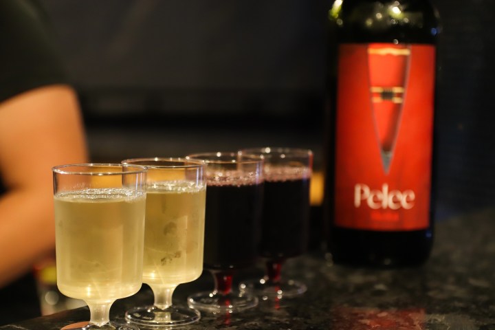 a close up of a bottle and a glass of wine