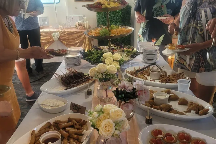 a group of people sitting at a table with a plate of food