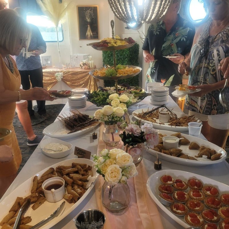 a group of people sitting at a table with a plate of food