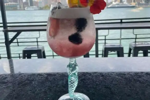 a vase sitting on a bench in front of a window