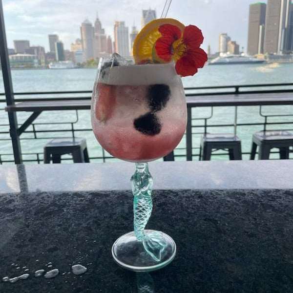 a vase sitting on a bench in front of a window