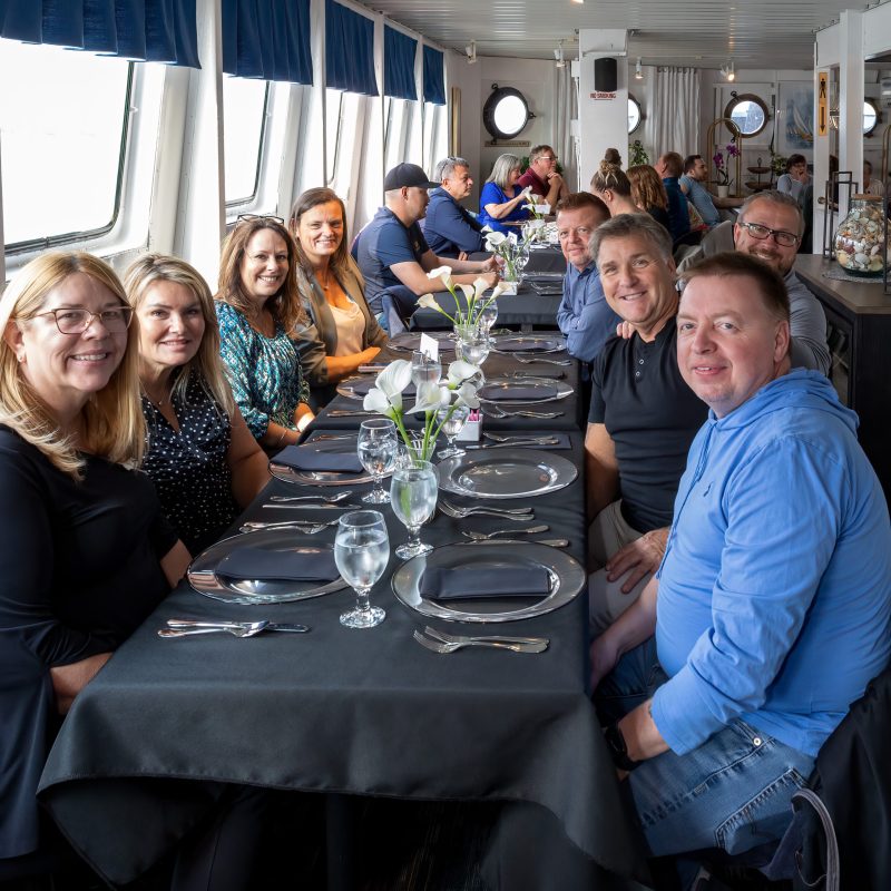 a group of people sitting at a table with wine glasses