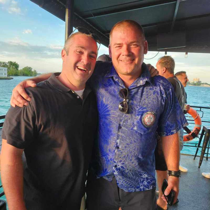 a group of people standing next to a man