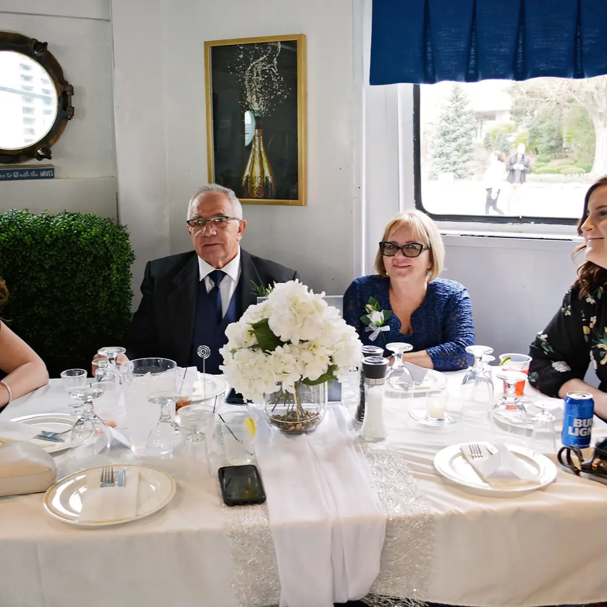 a group of people sitting at a table with wine glasses
